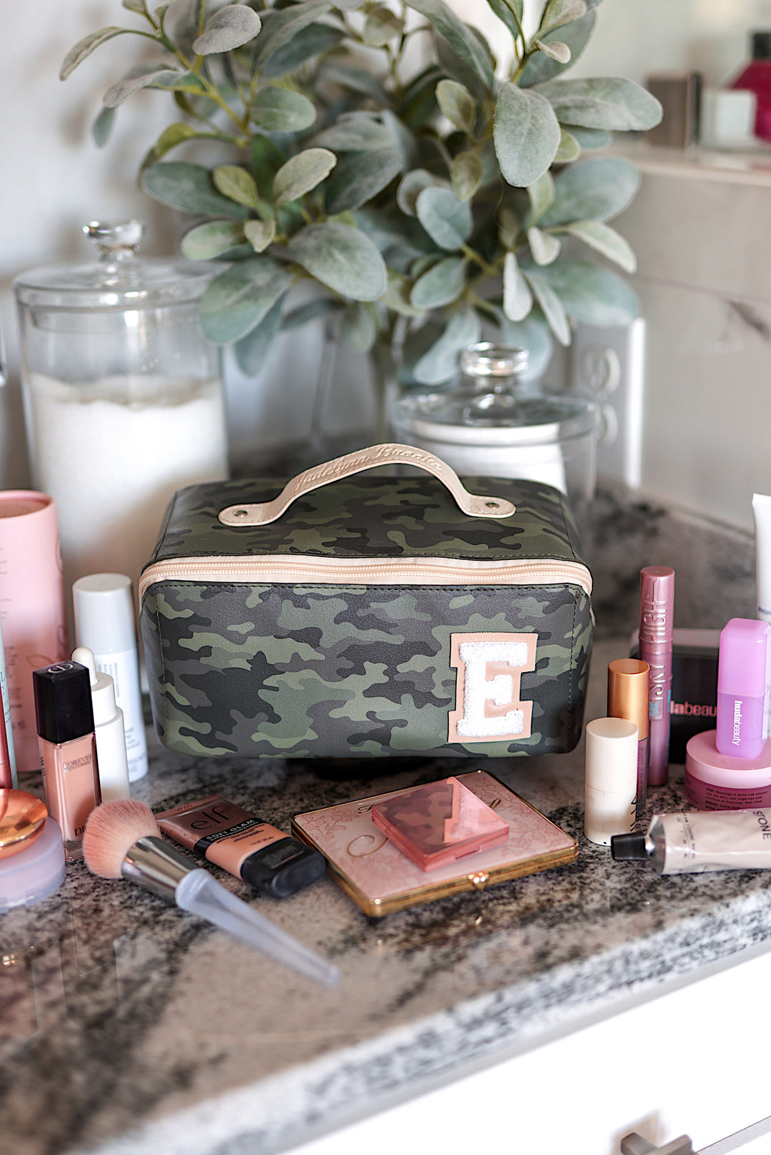 Camouflage makeup bag with handle and initial E, perfect for organizing beauty products.