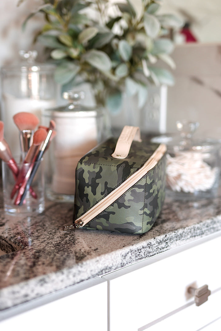 Camouflage makeup bag with gold zipper, stylish and durable for organizing beauty essentials.