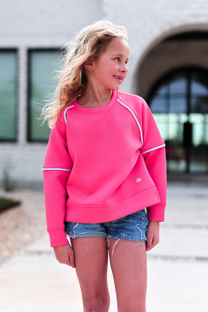 Youth pink sweatshirt featuring a relaxed fit and contrast stitching, perfect for casual wear.