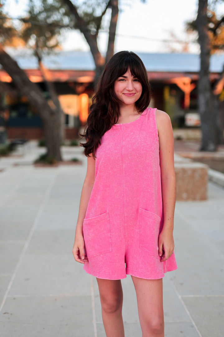 Pink cotton romper dress with pockets, perfect for warm weather casual outings and stylish comfort.