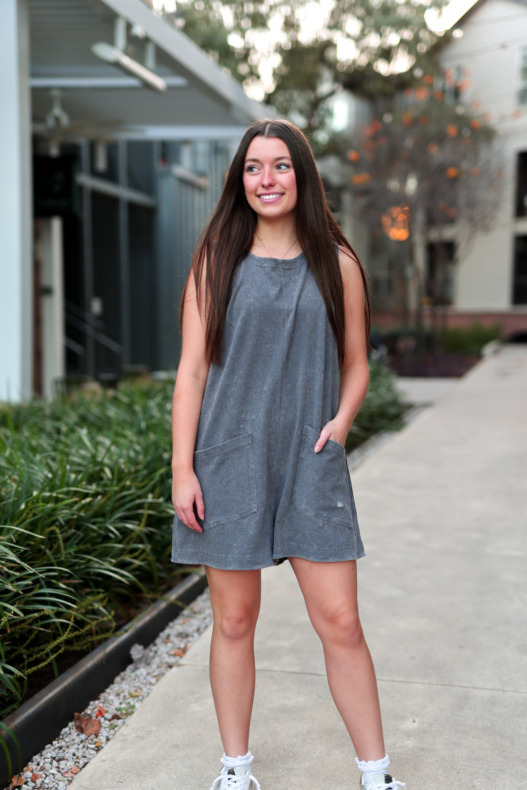 Women's casual gray cotton sleeveless romper with pockets, perfect for summer outings.