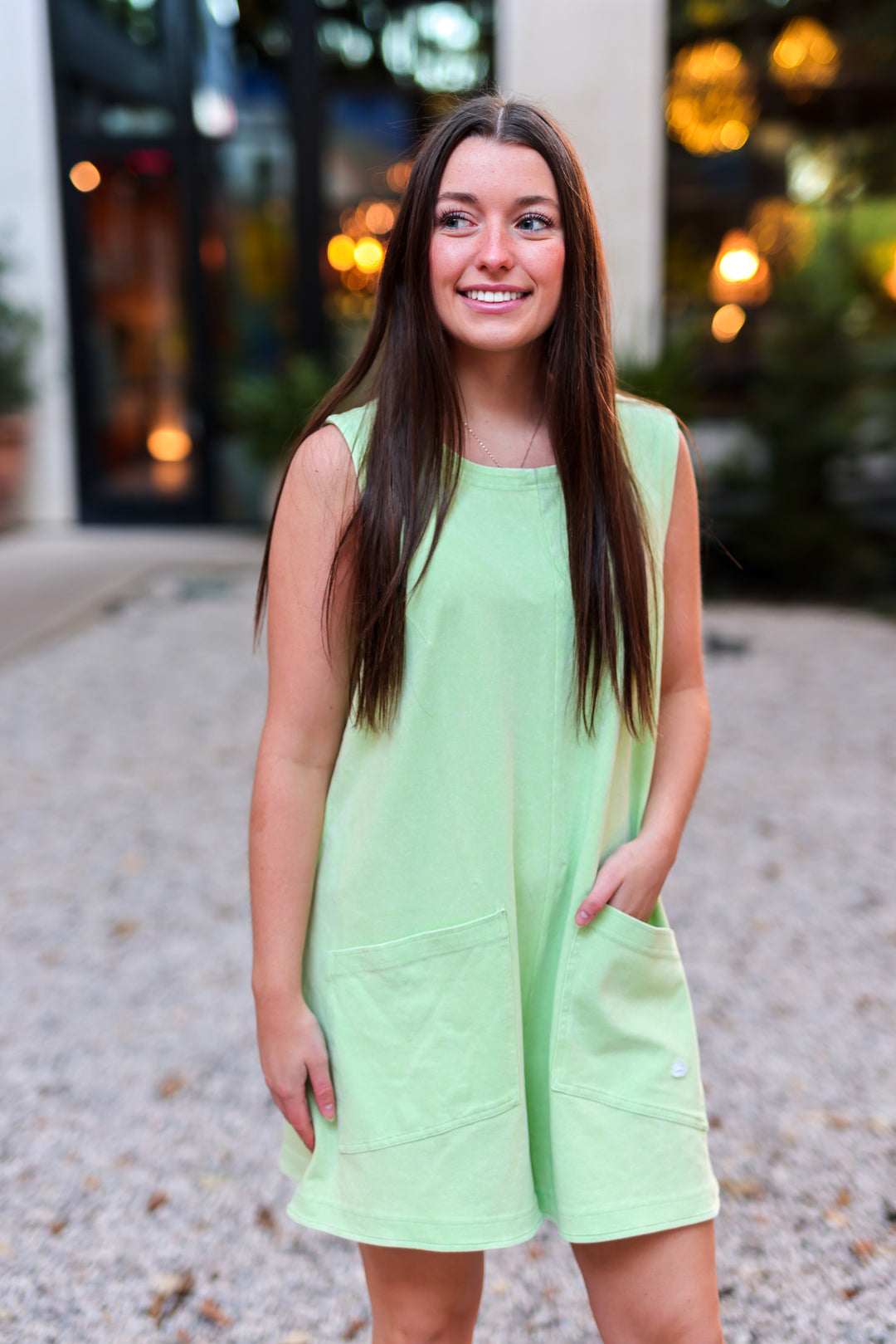 Light green sleeveless dress with pockets, perfect for casual wear and summer outings.