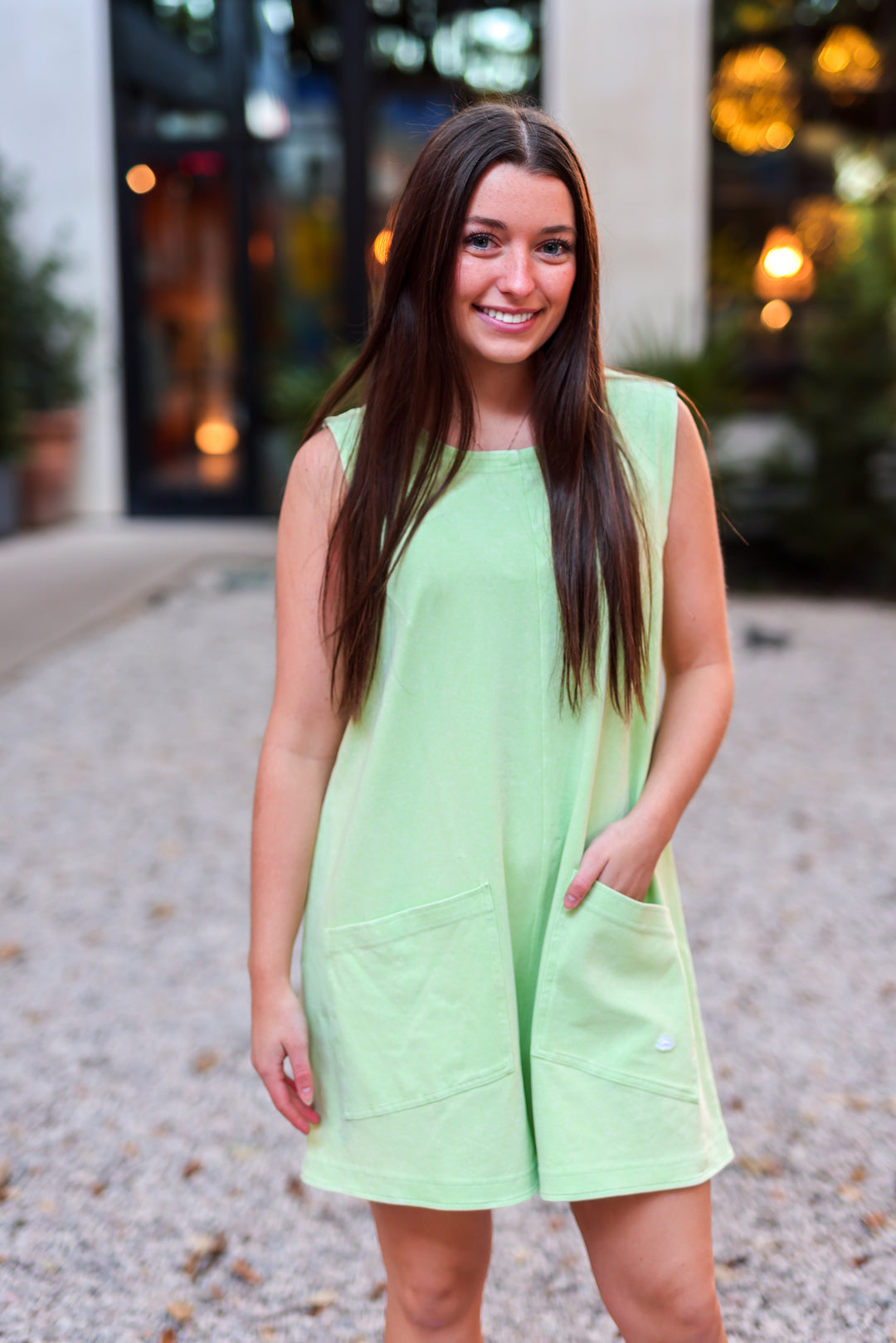 Light green sleeveless romper with pockets, perfect for summer casual wear.