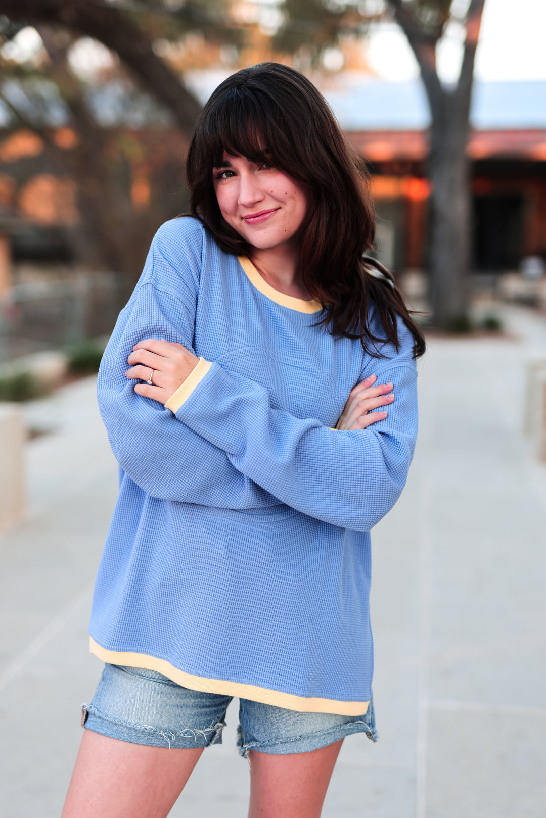Cozy blue waffle knit sweater with yellow trim, perfect for casual wear in any season.