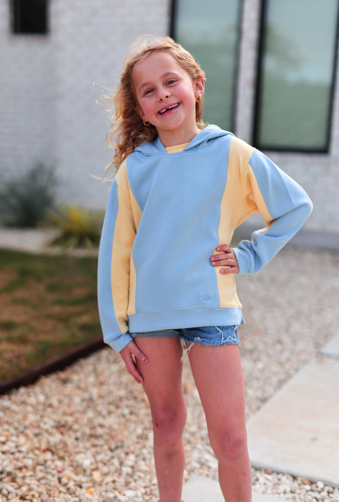 Light blue and yellow kids' hoodie, soft material, cozy design, perfect for casual wear.