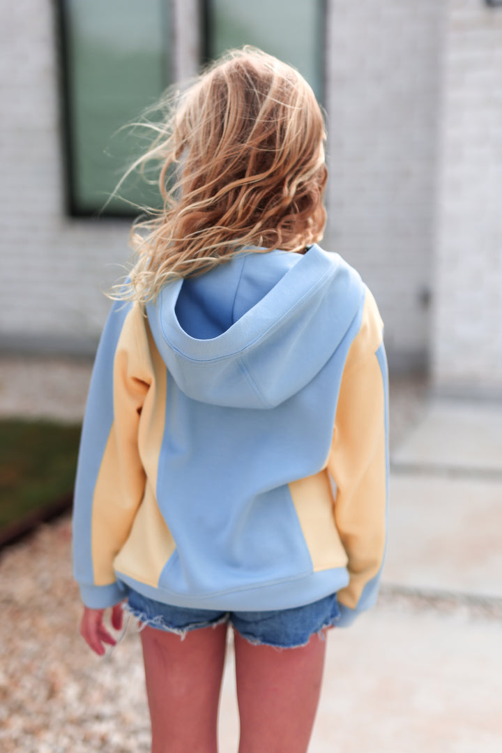 Youth colorblock hoodie in light blue and yellow, soft cotton blend, perfect for casual wear.