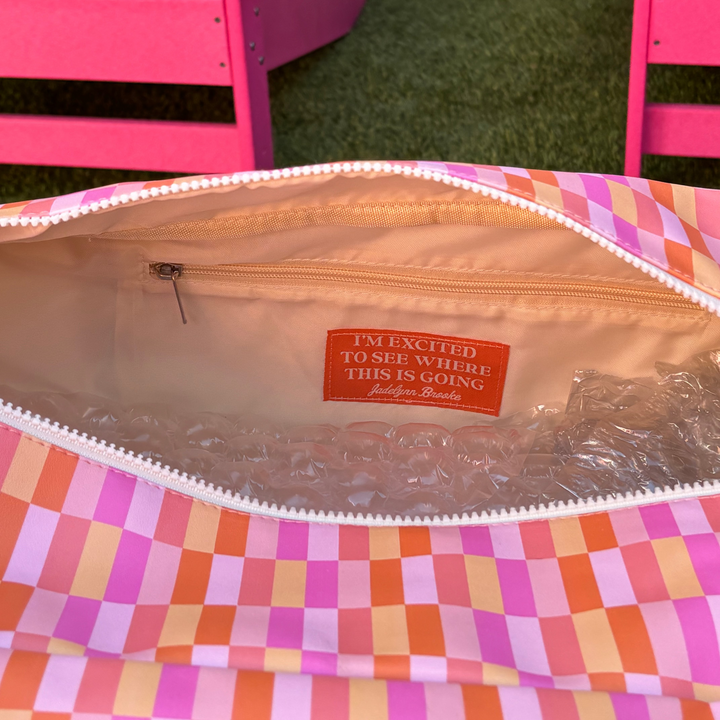 Colorful checkered tote bag interior with zip pocket and motivational quote, ideal for everyday use.