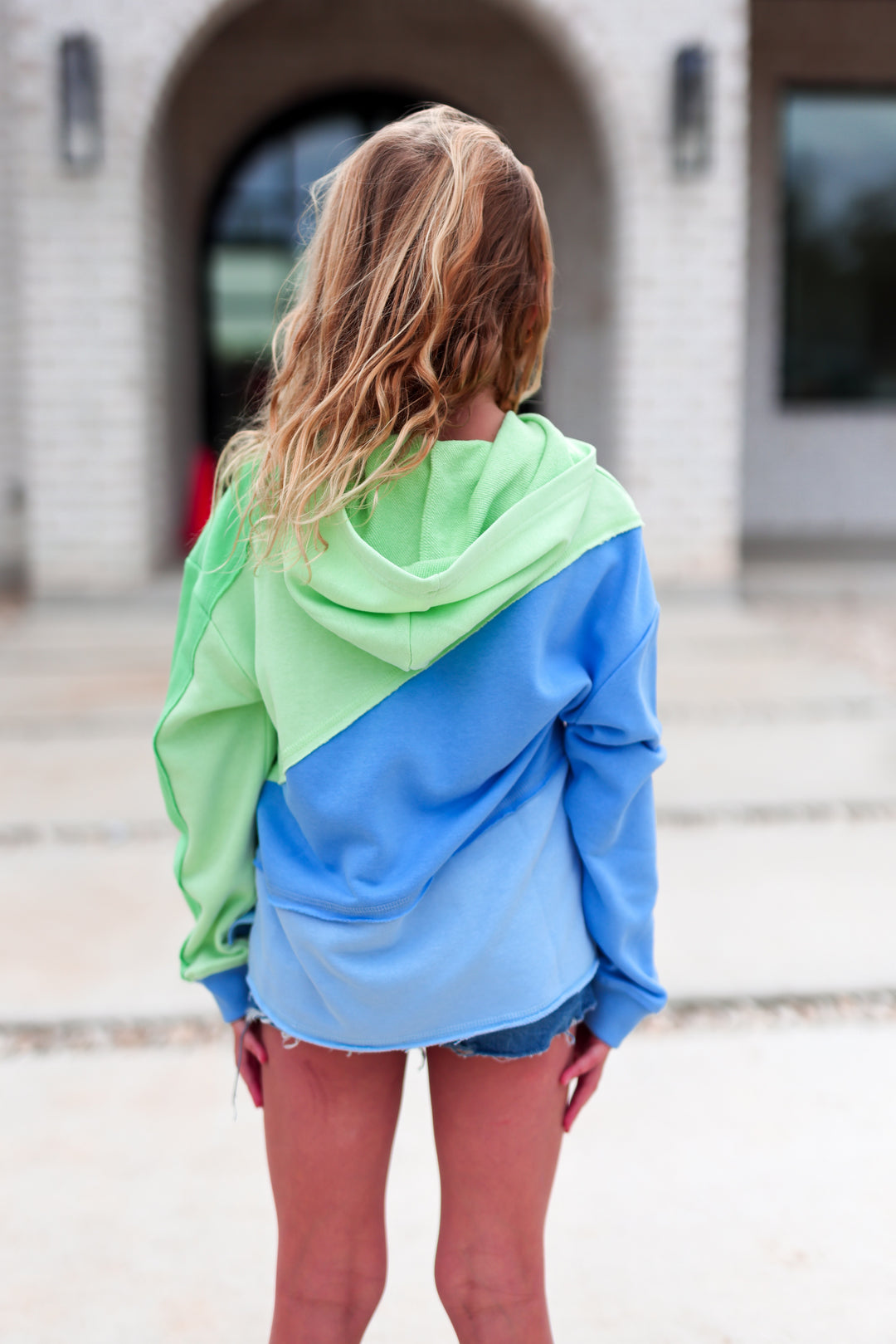 Color-blocked hoodie in green and blue, casual style, cozy fabric, perfect for layering.
