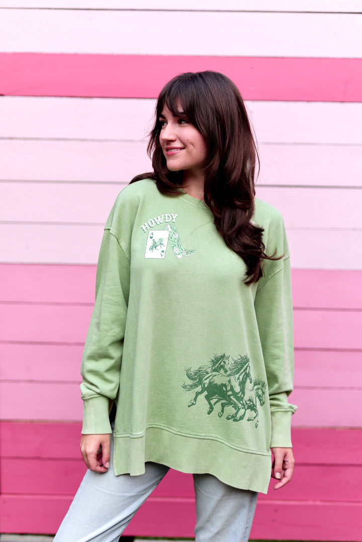 Green oversized sweatshirt with 'Howdy' graphic and horse print, perfect for casual wear.