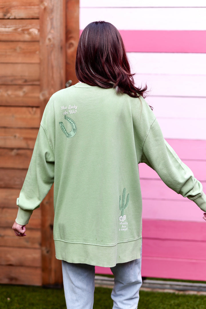 Oversized green sweatshirt with cactus and horseshoe embroidery, casual style for women.