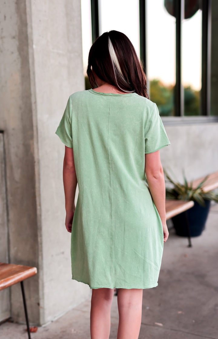 Back view of a light green short sleeve dress made of soft fabric, perfect for casual outings.