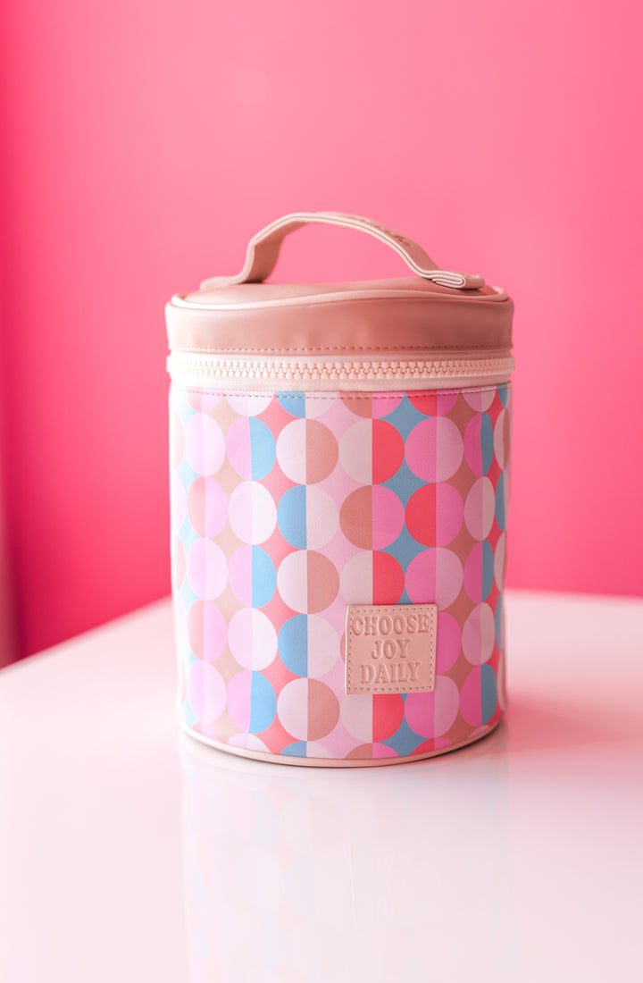Colorful round storage bag in pink and blue geometric patterns with a handle and zip closure.