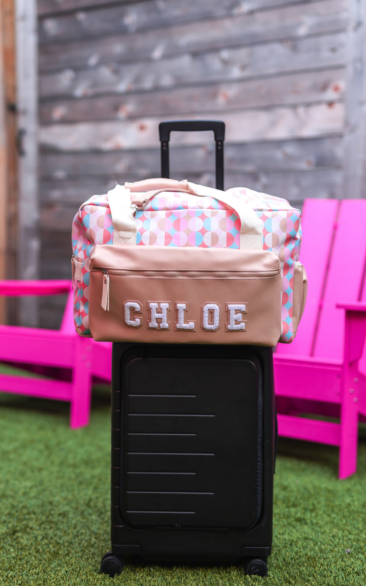 Chic multicolor duffel bag with personalized name 'CHLOE', designed for travel and style.
