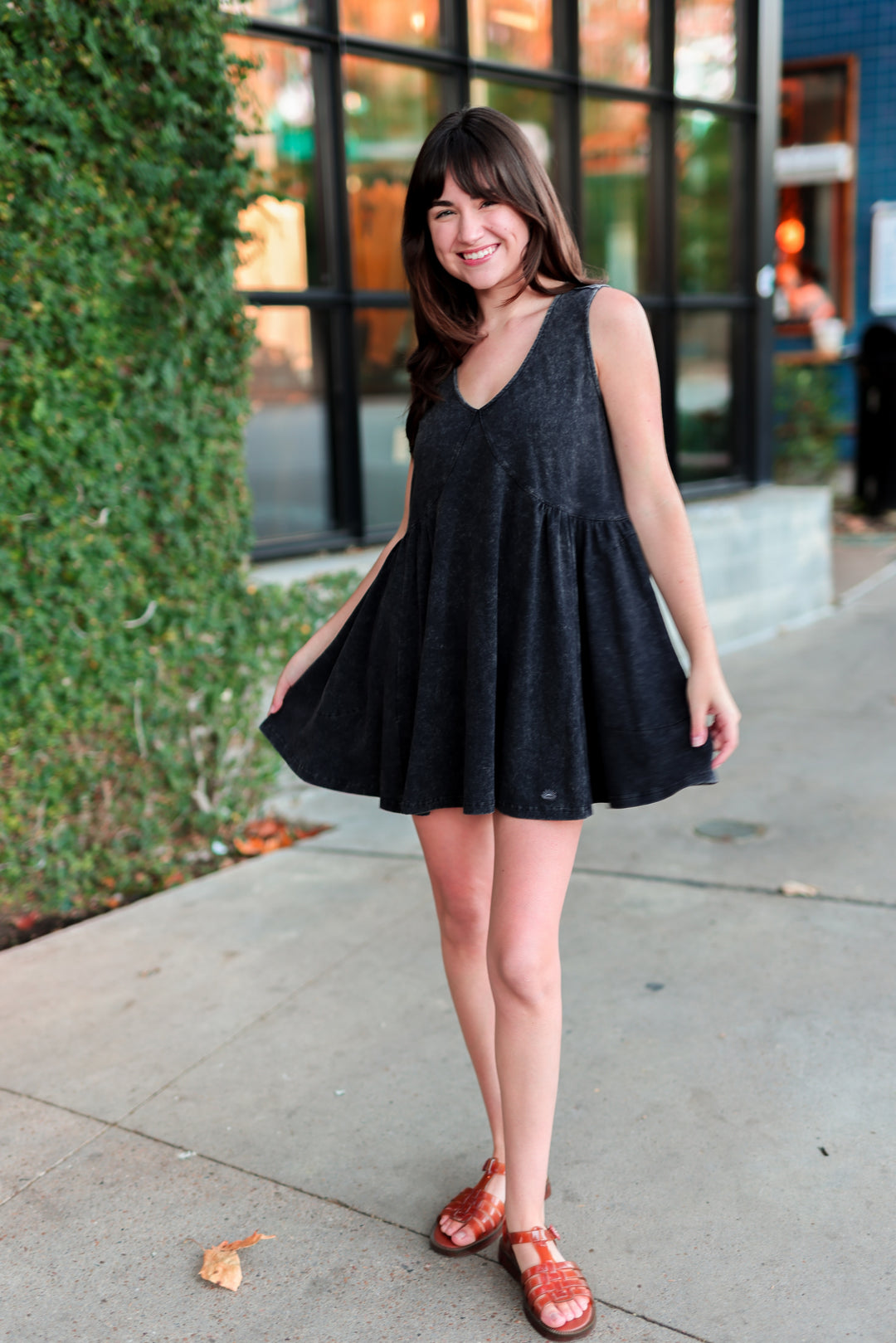 Casual black sleeveless dress with flared skirt, perfect for summer outings.