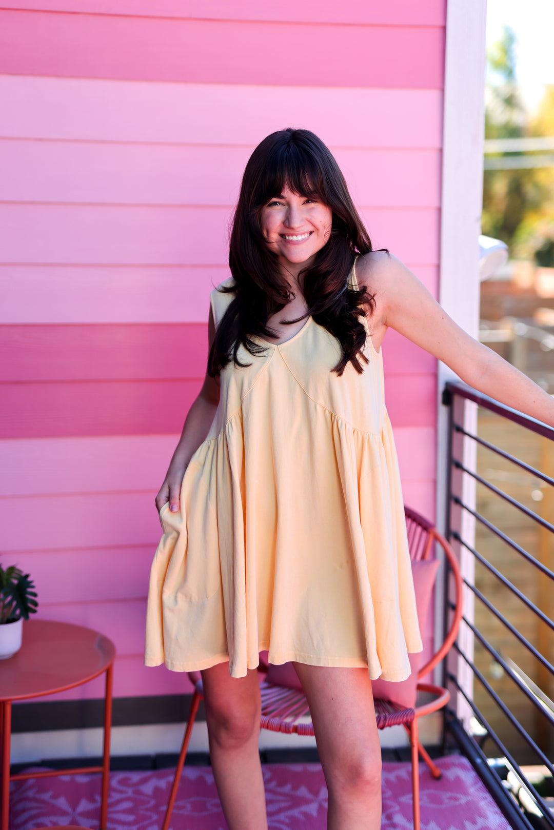 Light yellow sleeveless dress with a flowy design, perfect for casual summer outings.