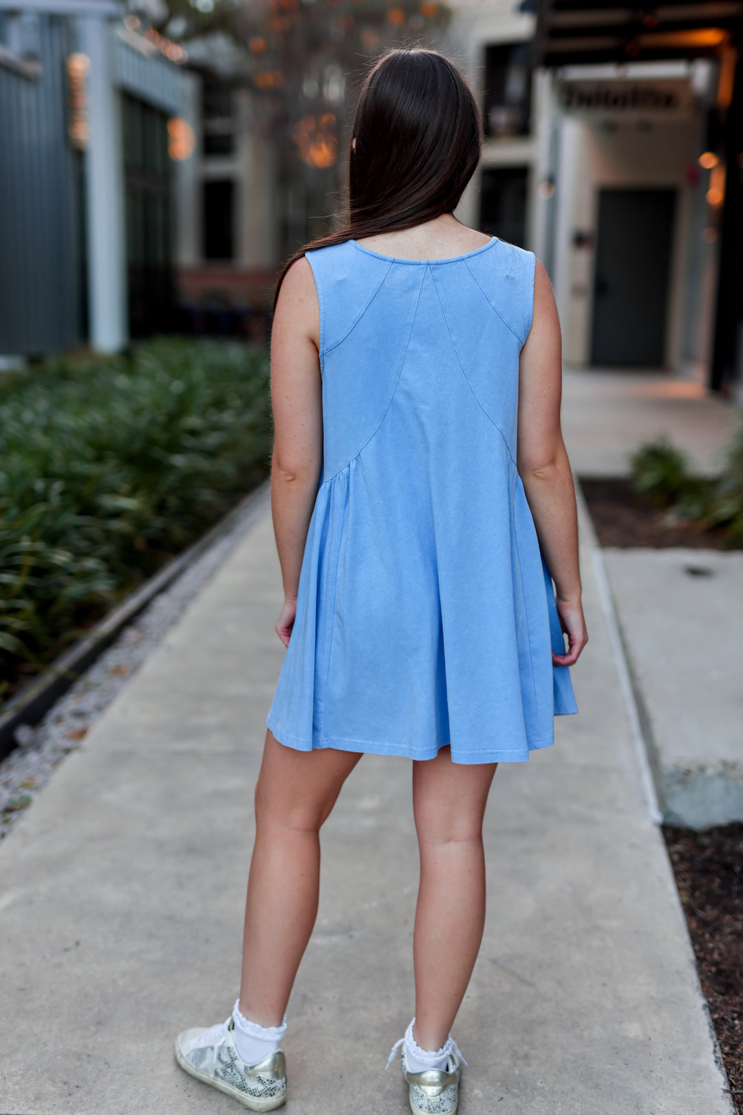 Light blue sleeveless dress made of soft fabric, featuring a flared skirt and stylish back seams.