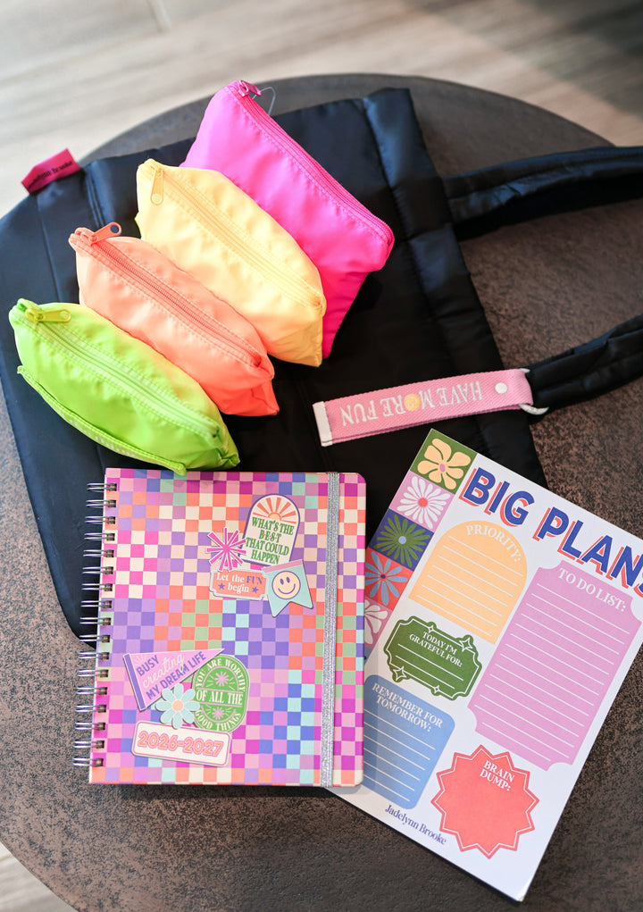 Colorful pouches and planners on a table