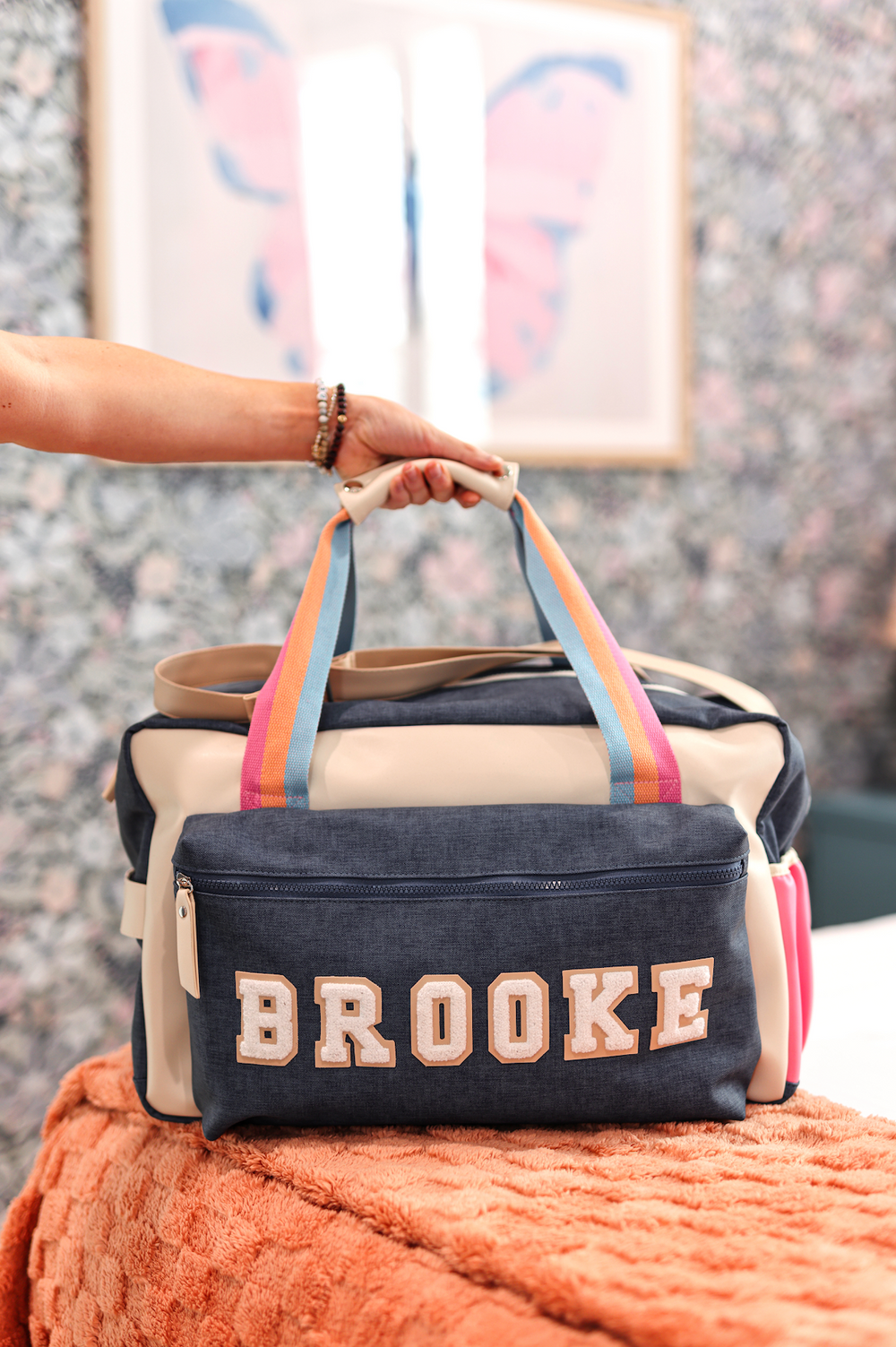 Stylish navy and cream duffel bag with colorful straps and personalized 'BROOKE' detail.