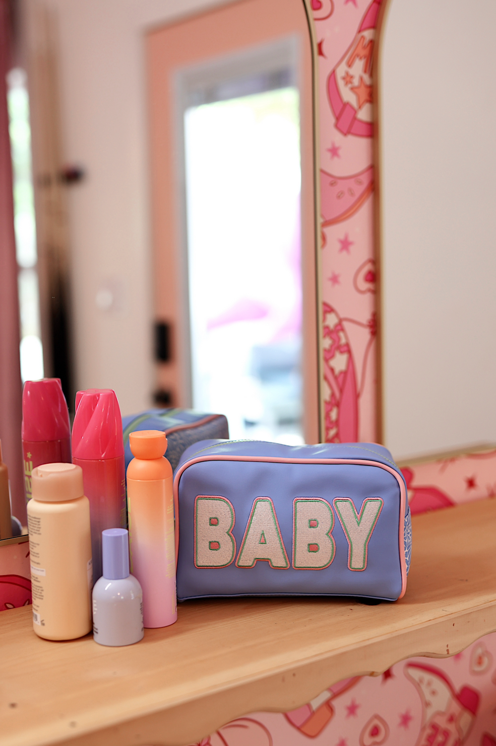Light blue makeup bag with 'BABY' text, stylish design, perfect for organizing beauty products.