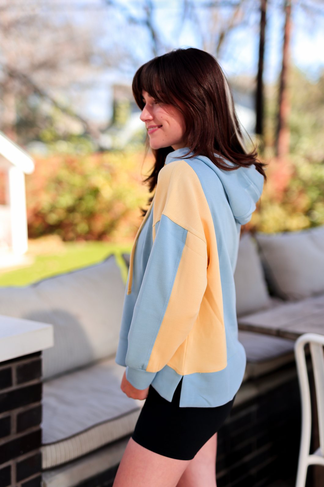 Stylish two-tone hoodie in blue and yellow, featuring a relaxed fit and soft material, perfect for casual wear.