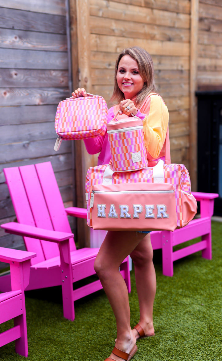 Personalized pink and white checkered duffel bag with matching lunch bag and backpack.