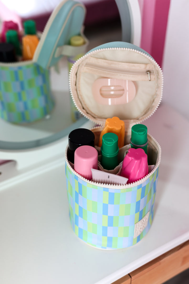Colorful patterned cosmetic bag with zip, holding various beauty products and containers
