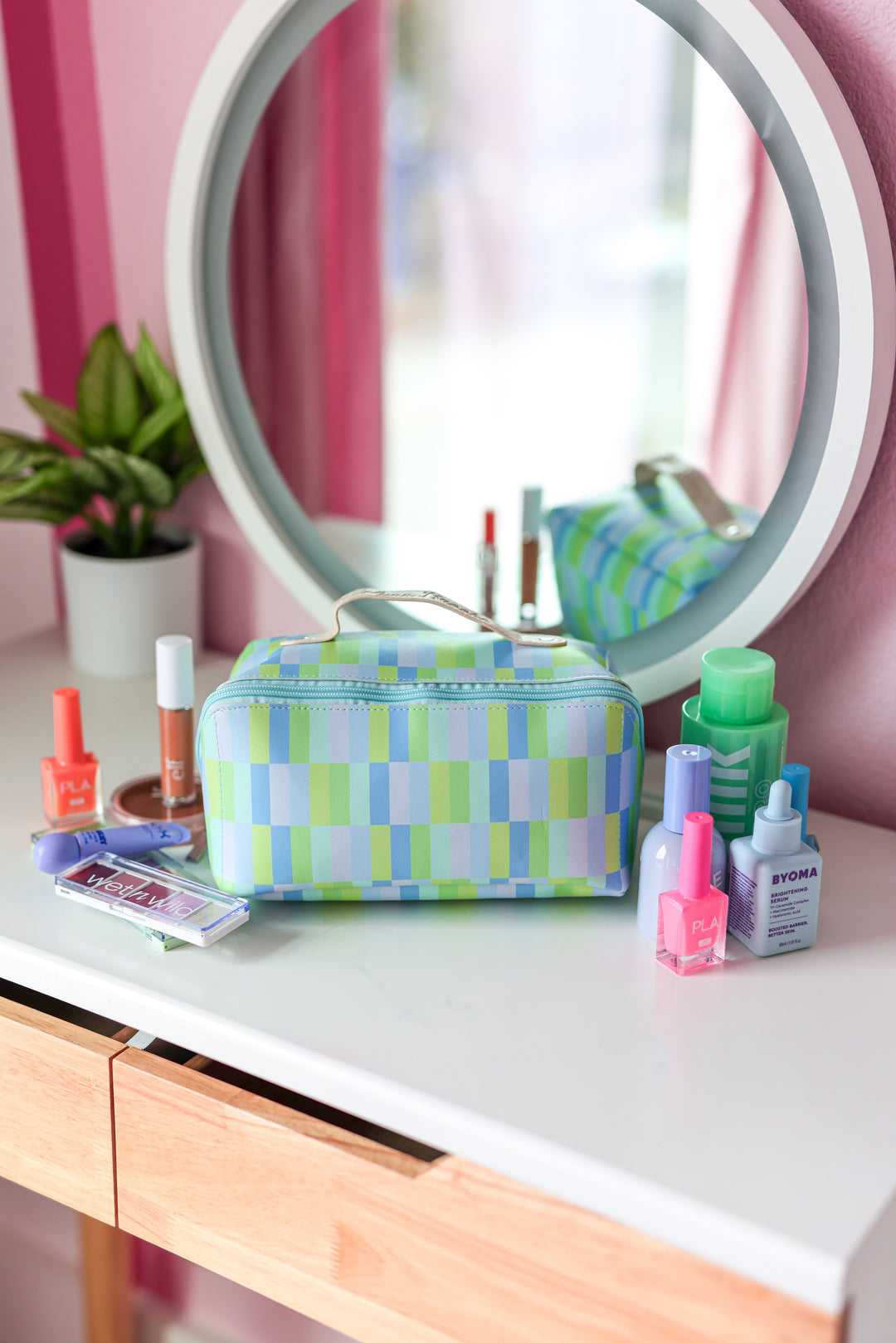 Colorful geometric makeup bag in blue and green, perfect for organizing cosmetics and accessories.