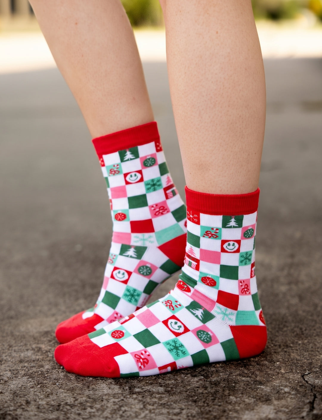 Women's checkered christmas socks with holiday icons.